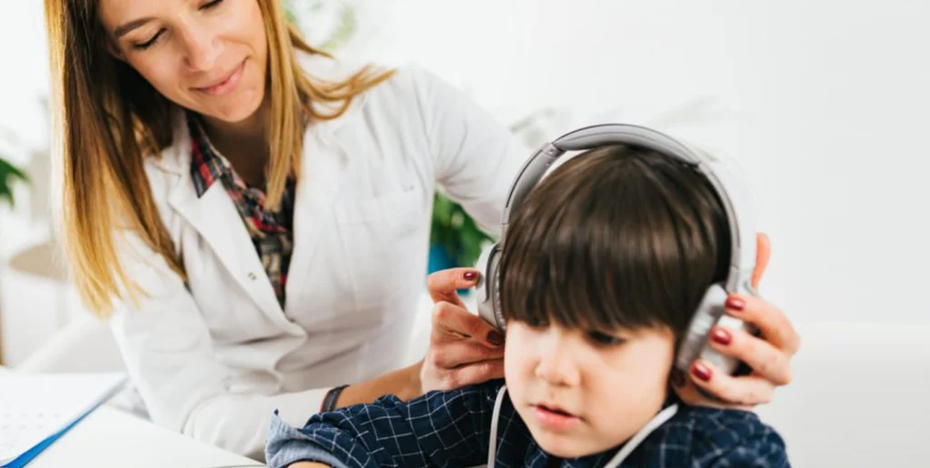 Woman putting headphone on child