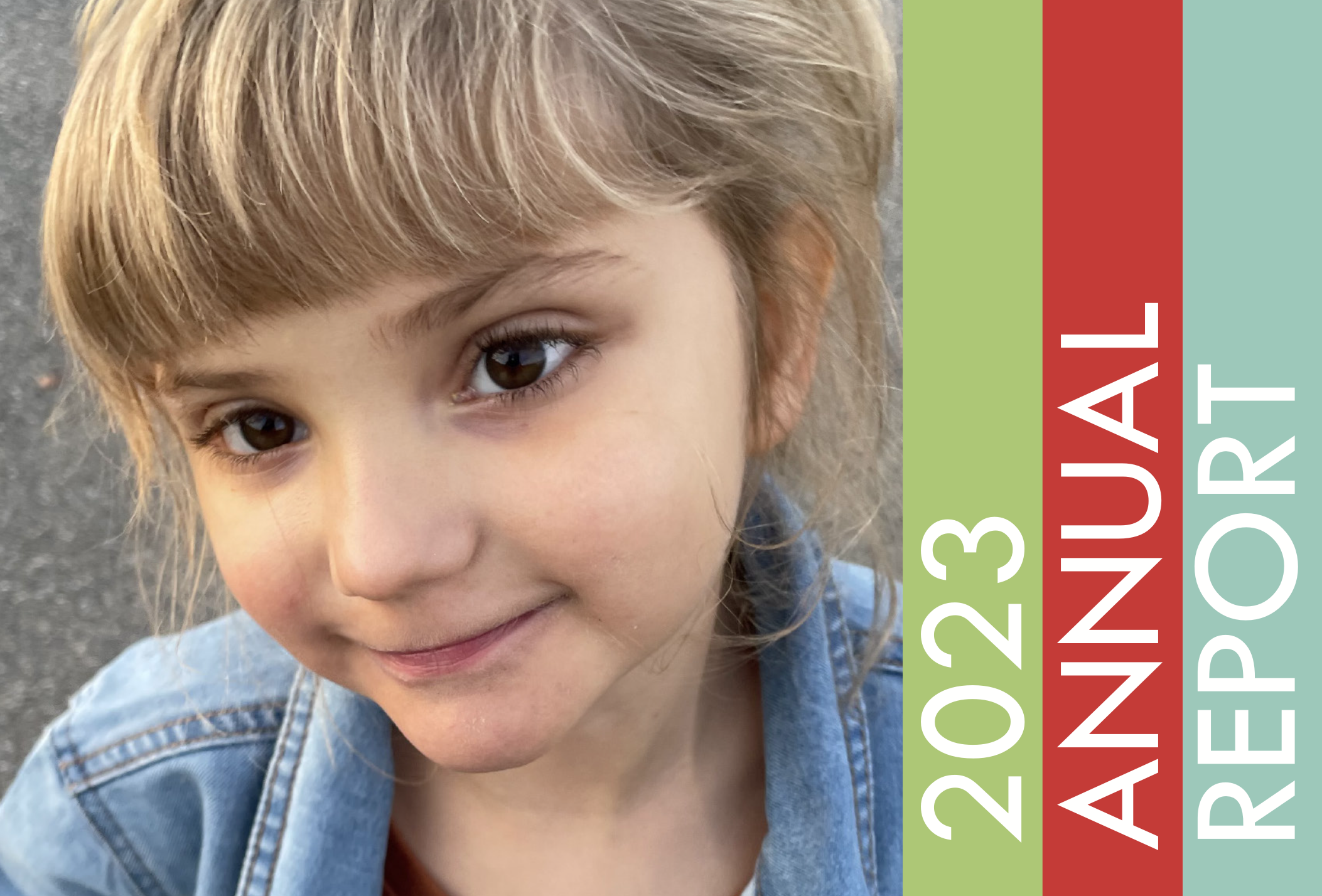 Child smiling at the camera, 2023 Annual Report written on the right side